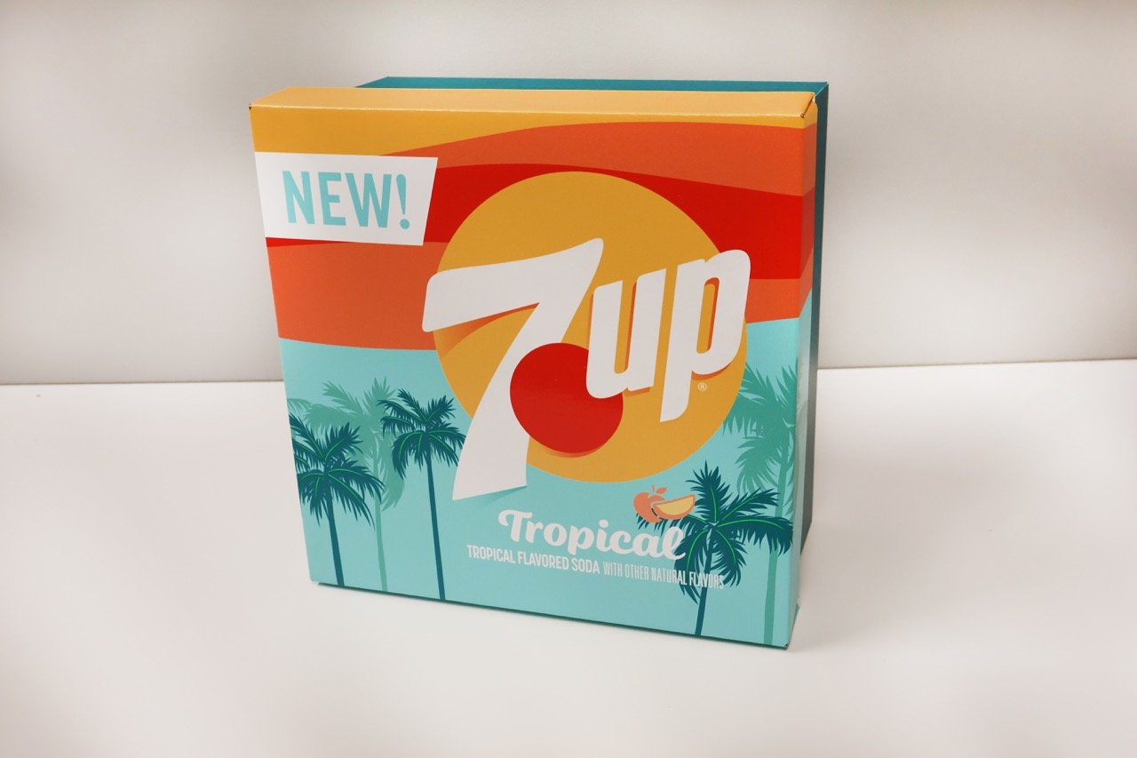 Closed 7UP Tropical influencer kit with orange and turquoise packaging and palm tree graphics